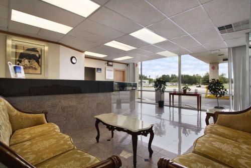 a waiting room with chairs and a table in a building at Super 8 by Wyndham Dover in Dover