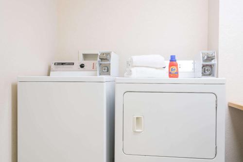 a white refrigerator with a counter top on top of it at Super 8 by Wyndham Sheldon in Sheldon