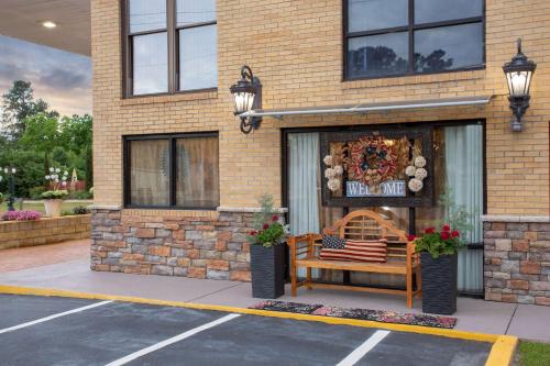 a store with a bench in front of a building at Days Inn by Wyndham Lake City in Lake City