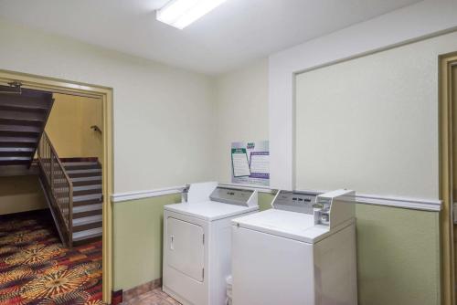 a laundry room with two washing machines and a staircase at Super 8 by Wyndham Dandridge in Dandridge