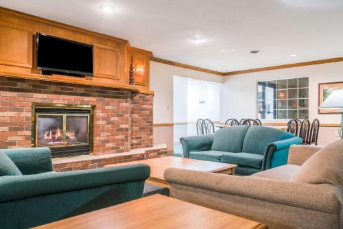 a living room with chairs and a fireplace at Super 8 by Wyndham Sheldon in Sheldon