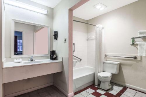 a bathroom with a sink and a toilet and a bath tub at Super 8 by Wyndham New Orleans in New Orleans