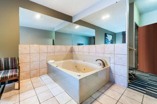 a large bathroom with a tub in a room at Super 8 by Wyndham Fort Worth North in Fort Worth