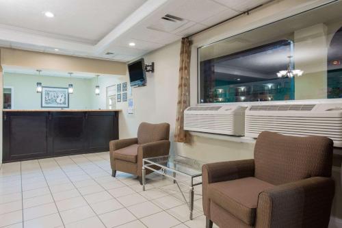 a waiting room with two chairs and a window at Super 8 by Wyndham Augusta in Augusta