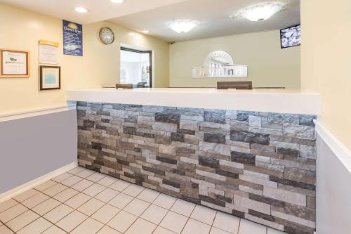a bar in a dental office with a brick wall at Days Inn by Wyndham Kent - Akron in Kent