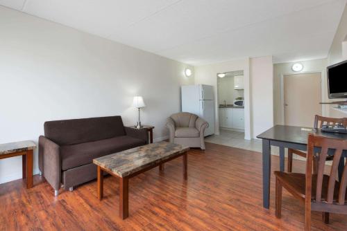 a living room with a couch and a table at Super 8 by Wyndham Cambridge/Kitchener/Waterloo Area in Cambridge