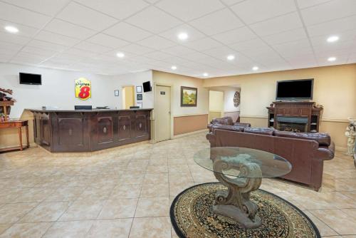 a living room with a couch and a table at Super 8 by Wyndham Cambridge/Kitchener/Waterloo Area in Cambridge