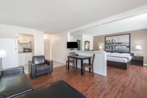 a hotel room with a bed and a table at Super 8 by Wyndham Cambridge/Kitchener/Waterloo Area in Cambridge