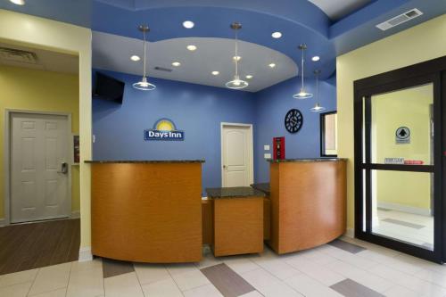 a lobby of a dental office with a blue wall at Days Inn by Wyndham Fultondale in Fultondale