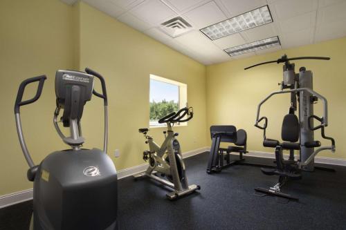 a gym with three exercise bikes in a room at Days Inn by Wyndham Fultondale in Fultondale