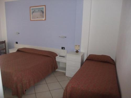 Letto o letti in una camera di Hotel Adriana