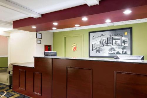 a waiting room with a counter in a hospital at Super 8 by Wyndham Bangor in Bangor