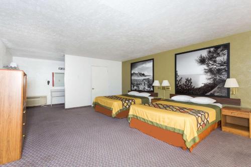 a hotel room with two beds in a room at Super 8 by Wyndham Wells in Wells