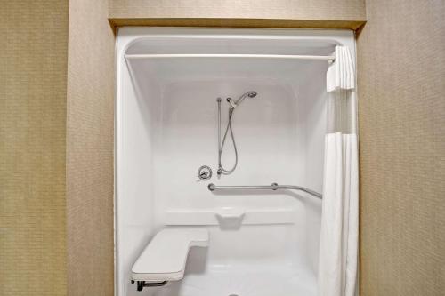 a bathroom with a shower and a toilet and a tub at Super 8 by Wyndham Knoxville East in Knoxville