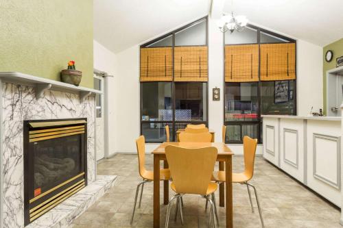 a dining room with a table and a fireplace at Super 8 by Wyndham Wells in Wells