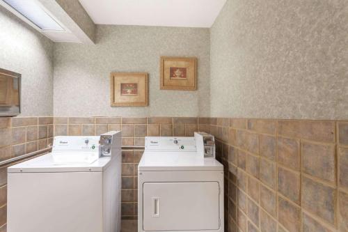 a laundry room with a washer and dryer at Super 8 by Wyndham Erwin, I-26 Exit 37 in Erwin