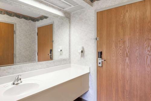 a bathroom with a sink and a mirror at Super 8 by Wyndham Erwin in Erwin