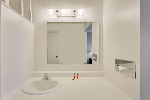 a white bathroom with a sink and a mirror at Super 8 by Wyndham Alturas in Alturas