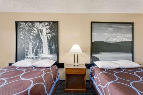 a hotel room with two beds and a lamp at Super 8 by Wyndham Alturas in Alturas
