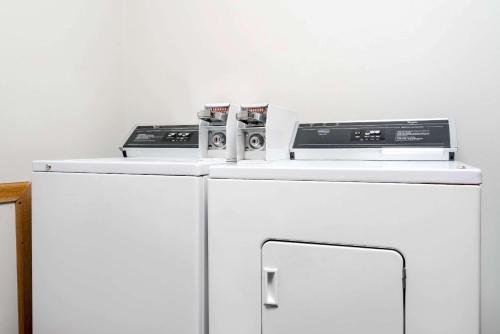 two appliances sitting on top of a white refrigerator at Super 8 by Wyndham Sparta in Sparta