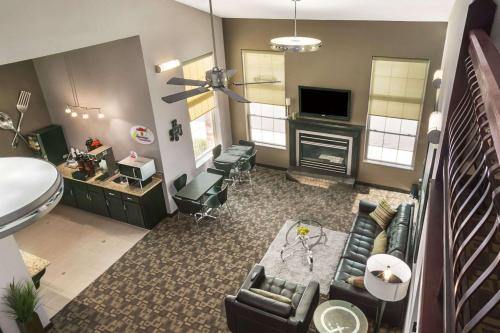 a living room with a couch and a fireplace at Super 8 by Wyndham Stafford/Springfield Area in Strafford