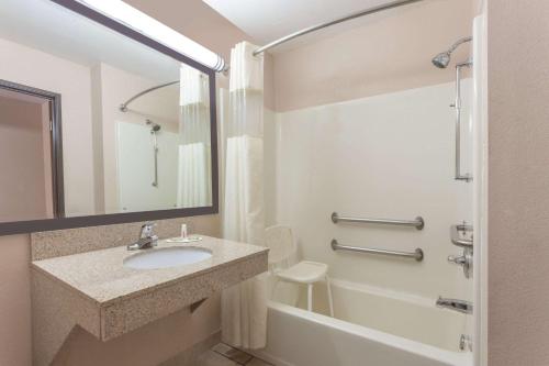 a bathroom with a sink and a tub and a toilet at Super 8 by Wyndham Carrollton in Carrollton