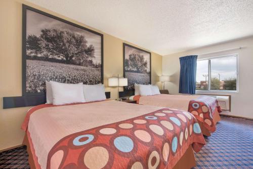 a hotel room with two beds and a window at Super 8 by Wyndham College Station in College Station