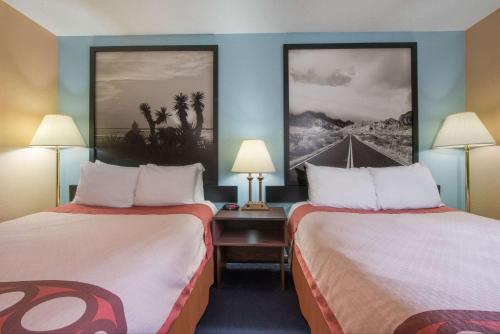 a hotel room with two beds and two lamps at Super 8 by Wyndham College Station in College Station