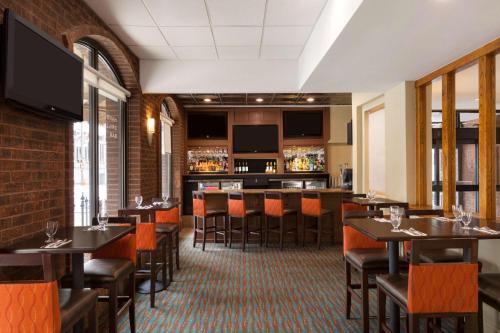 a restaurant with tables and chairs and a bar at Days Inn by Wyndham Baltimore Inner Harbor in Baltimore