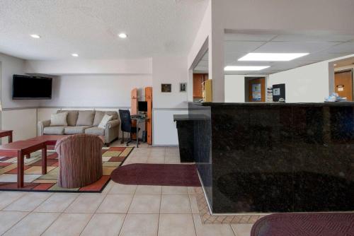 a living room with a couch and a table at Super 8 by Wyndham College Station in College Station