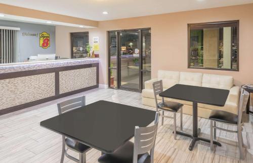 a restaurant with two tables and chairs and a counter at Super 8 by Wyndham Bryant Little Rock Area in Bryant