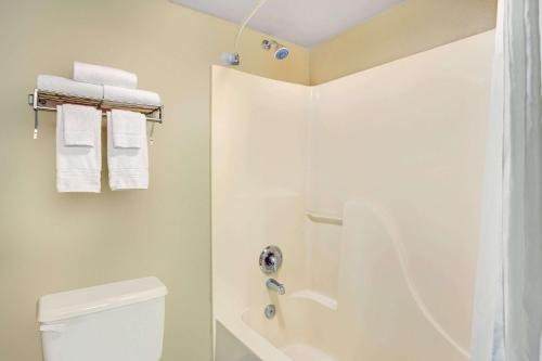 a bathroom with a shower and a toilet and towels at Super 8 by Wyndham Casa Grande in Casa Grande