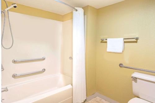 a bathroom with a tub and a toilet and a shower at Super 8 by Wyndham Jessup/Baltimore Area in Jessup