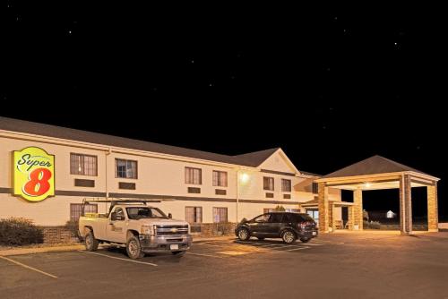 a truck parked in a parking lot in front of a building at Super 8 by Wyndham Defiance in Defiance
