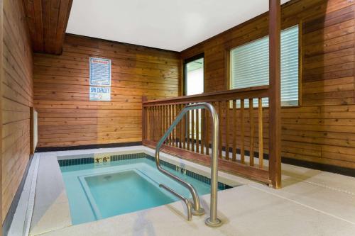 a jacuzzi tub in a room with wooden walls at Super 8 by Wyndham Green River in Green River