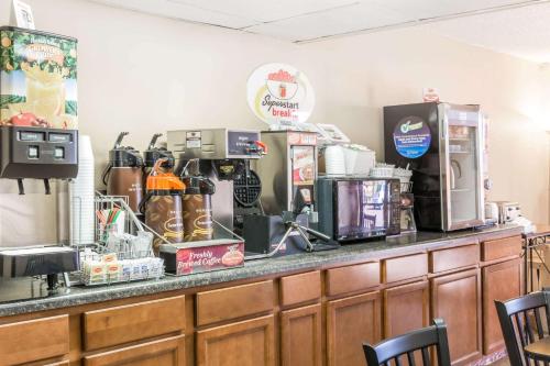 a coffee shop with a counter with coffee machines at Super 8 by Wyndham Luverne in Luverne