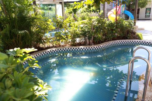 a swimming pool in a yard with trees and plants at The Mudan in Checheng