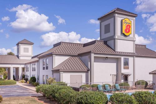 a large white building with a clock tower at Super 8 by Wyndham Greer/Spartanburg Area in Greer