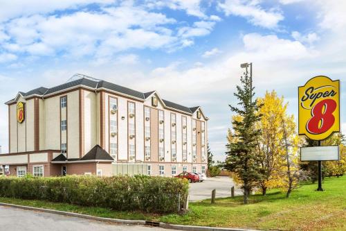 a hotel with a super sign in front of it at Super 8 by Wyndham Calgary/Airport in Calgary
