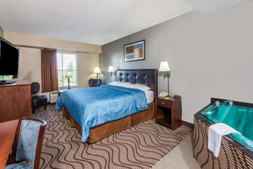 a hotel room with a bed and a television at Super 8 by Wyndham Mars/Cranberry/Pittsburgh Area in Cranberry Township