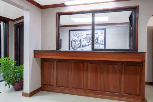 a large window in a room with a wooden door at Super 8 by Wyndham Waycross GA in Waycross