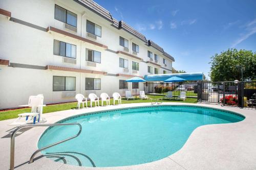 a swimming pool in front of a building at Days Inn by Wyndham Woodland in Woodland