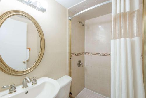 a bathroom with a sink and a shower with a mirror at Howard Johnson by Wyndham Rocky Hill in Rocky Hill