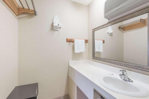 a bathroom with a sink and a mirror at Howard Johnson by Wyndham Rocky Hill in Rocky Hill