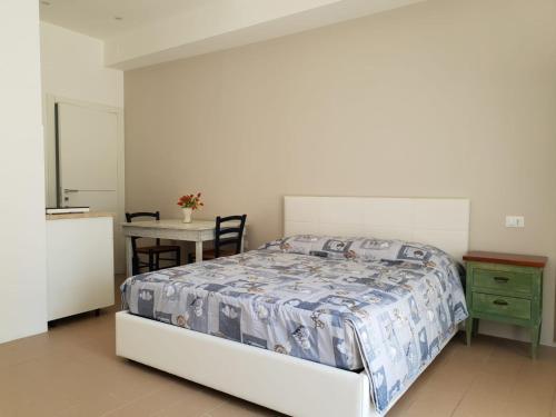 a bedroom with a bed and a table and a tableablish at MONOLOCALI B&B Santa Maria Apparente in Civitanova Marche