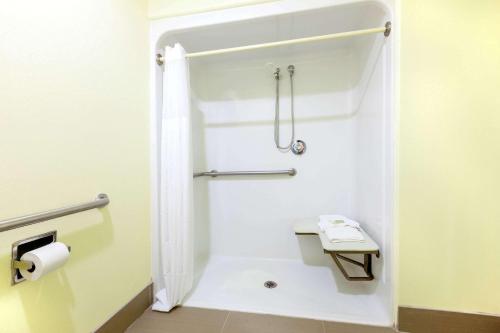 a small bathroom with a shower and a toilet at Super 8 by Wyndham Fairfield Tx in Fairfield