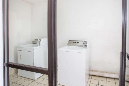 a mirror in a room with a washer and dryer at Super 8 by Wyndham Springdale AR in Springdale