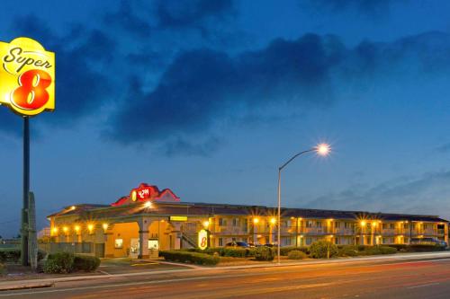 a hotel building with a sign in front of it at Super 8 by Wyndham Tucson Downtown Convention Center in Tucson