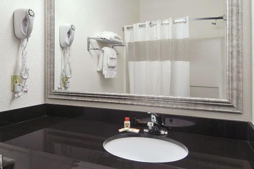 a bathroom with a sink and a mirror at Super 8 by Wyndham Bowling Green North in Bowling Green