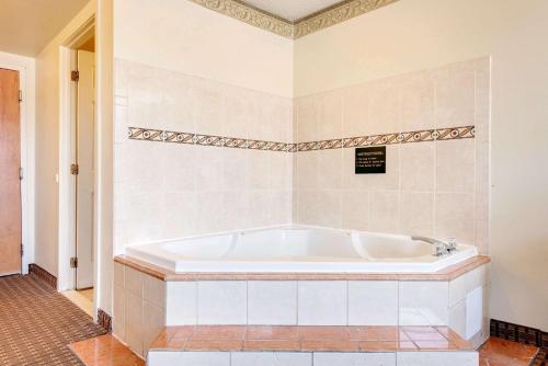 a white tub in a bathroom with a tile floor at Super 8 by Wyndham Allentown in Allentown